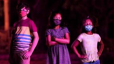 Three confident children with masks on