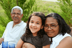 Grandparents with granddaughter on lap smiling