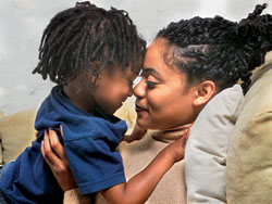 A mom and son give eskimo kisses.