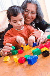 Grandma and boy playing with blocks
