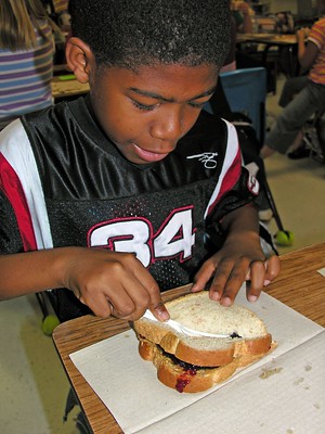 Young boy making a sandwich