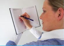 A woman writing in a notebook