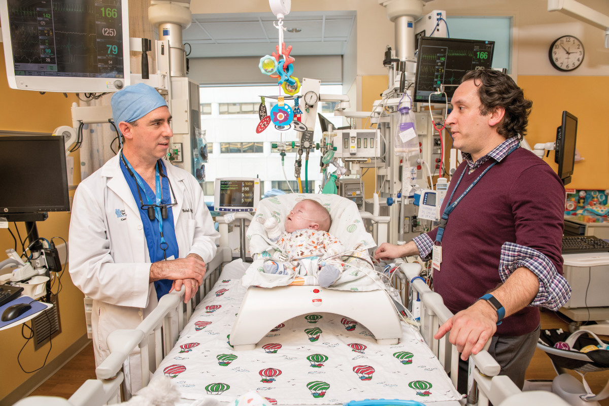 Photo  of providers helping a child in Children's Wisconsin's Cardiac Intensive Care Unit (CICU)