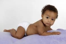 child on purple blanket on stomache