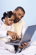 Dad and daughter learning about a laptop computer.