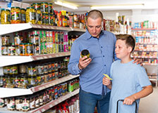 Man shopping in grocery store with his son