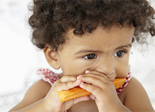 Little kid eating carrot