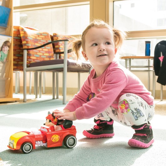 child playing with toy truck