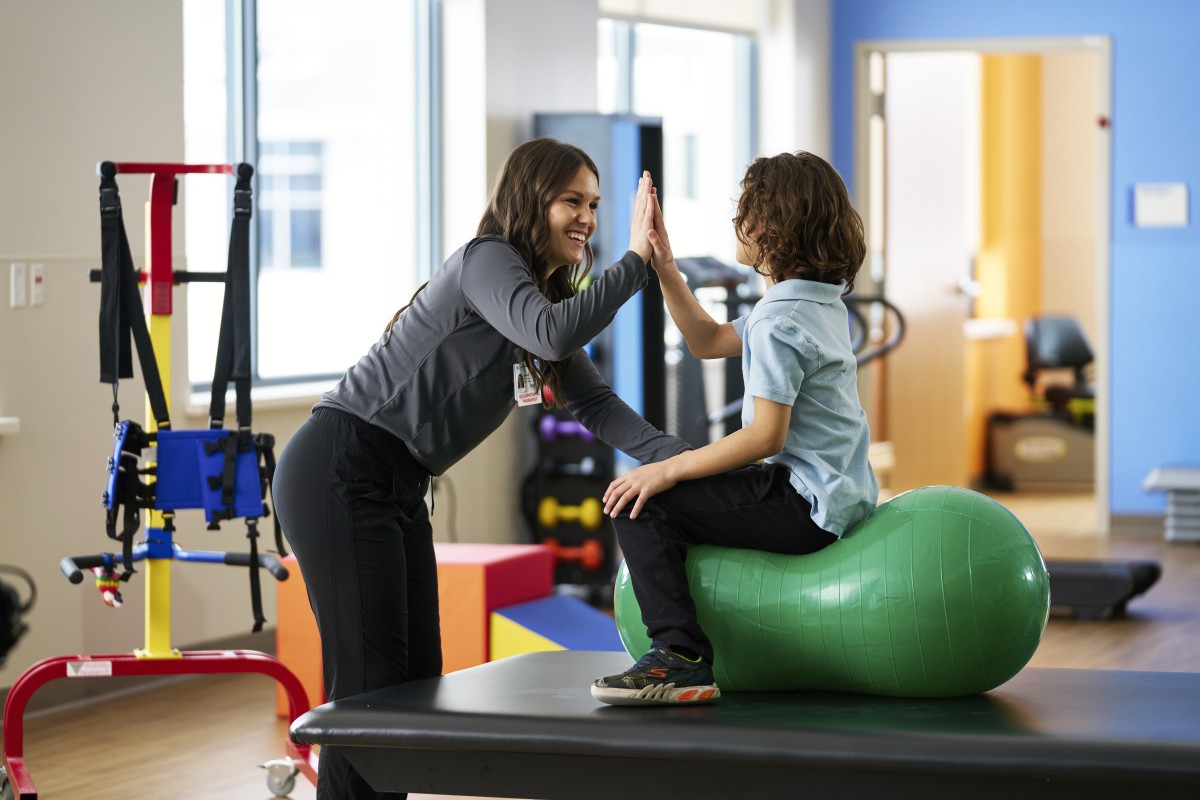 child on ball during physical therapy