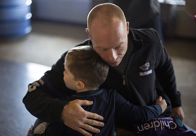 UW-Whitewater head men’s wheelchair basketball coach Jeremy “Opie” Lade gets a goodbye hug from patient Jake Granlund, 4, in the lobby of Children’s Wisconsin.