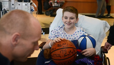 Boy in wheelchair with basketball