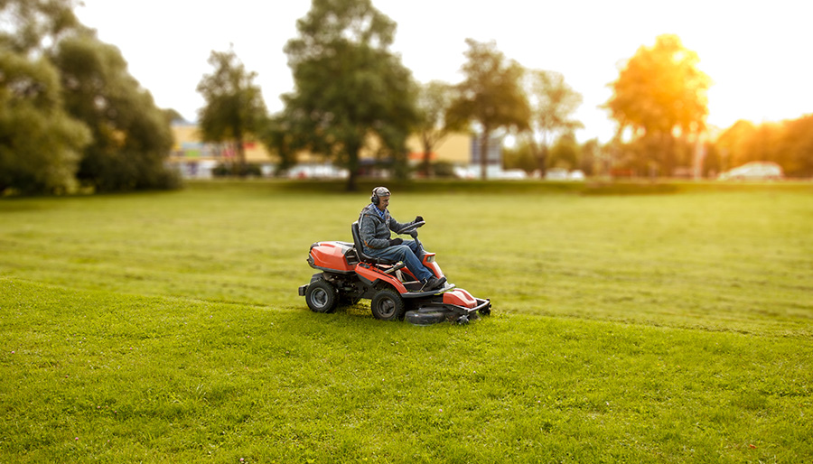 Child on riding online mower