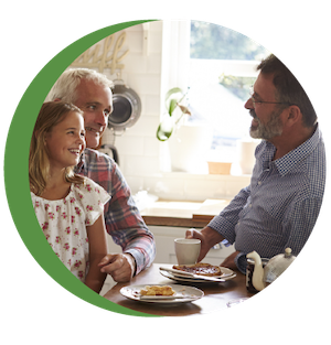 Two adults and a child talking and smiling