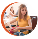 Child at school desk looking lonely