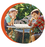 Photo of two children at a table not talking