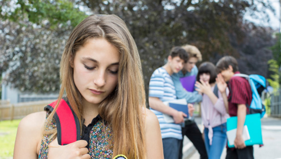 Photo of a girl being excluded from a group