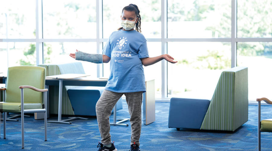 Greenfield clinic orthopedics patient young girl posing in cast in waiting room area